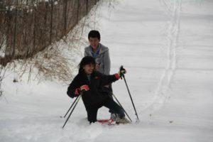 Awatin Skiers laugh as they climb the hill and set the first tracks in Eloise.