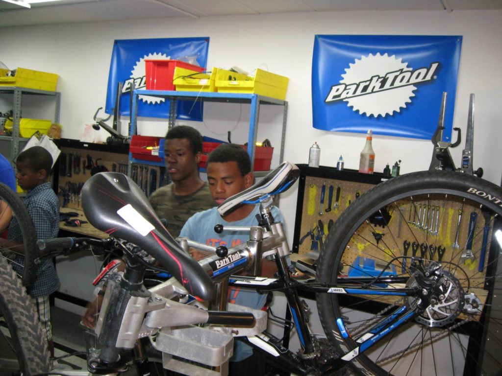 Figure 2: Jezier Bradley helping Bryce Holt tune his brakes